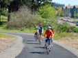 People riding bikes on a paved trail