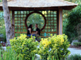 A couple sits in a quiet spot among the landscaping at the Gresham Japanese Garden.