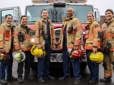 Firefighters posing with a fire truck at Fire Training Center