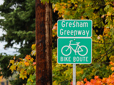 Gresham Greenway sign with fall trees in background.
