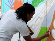 Youth painting a mural