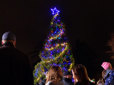 A crowd gathers at night on the Gresham Arts Plaza for the community tree lighting ceremony.