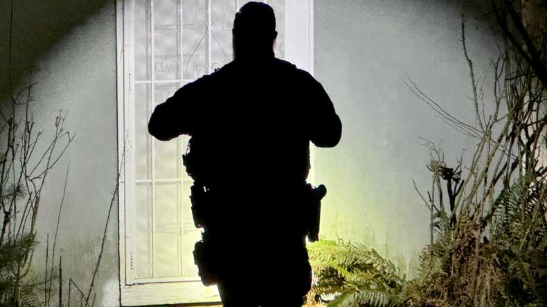 As night falls, Officer Adam approaches a home to respond to a disturbance call.