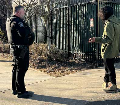 Officer Adam stops to talk with a resident during his shift.